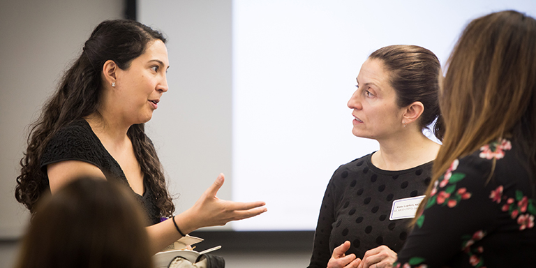 three women engaged in conversation