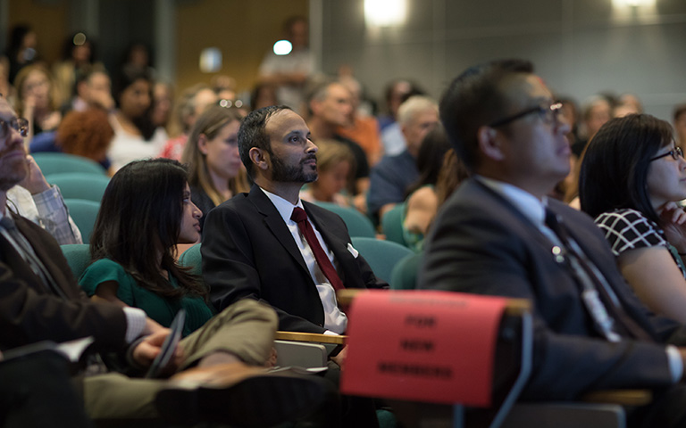 Seated audience of people attending celebration of new members