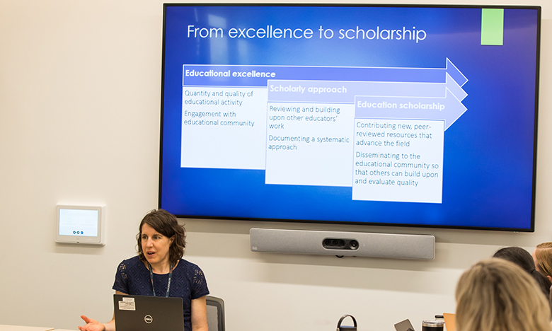 instructor leading class discussion with slideshow