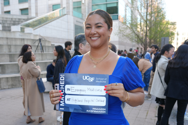 Person holding a sign standing outside