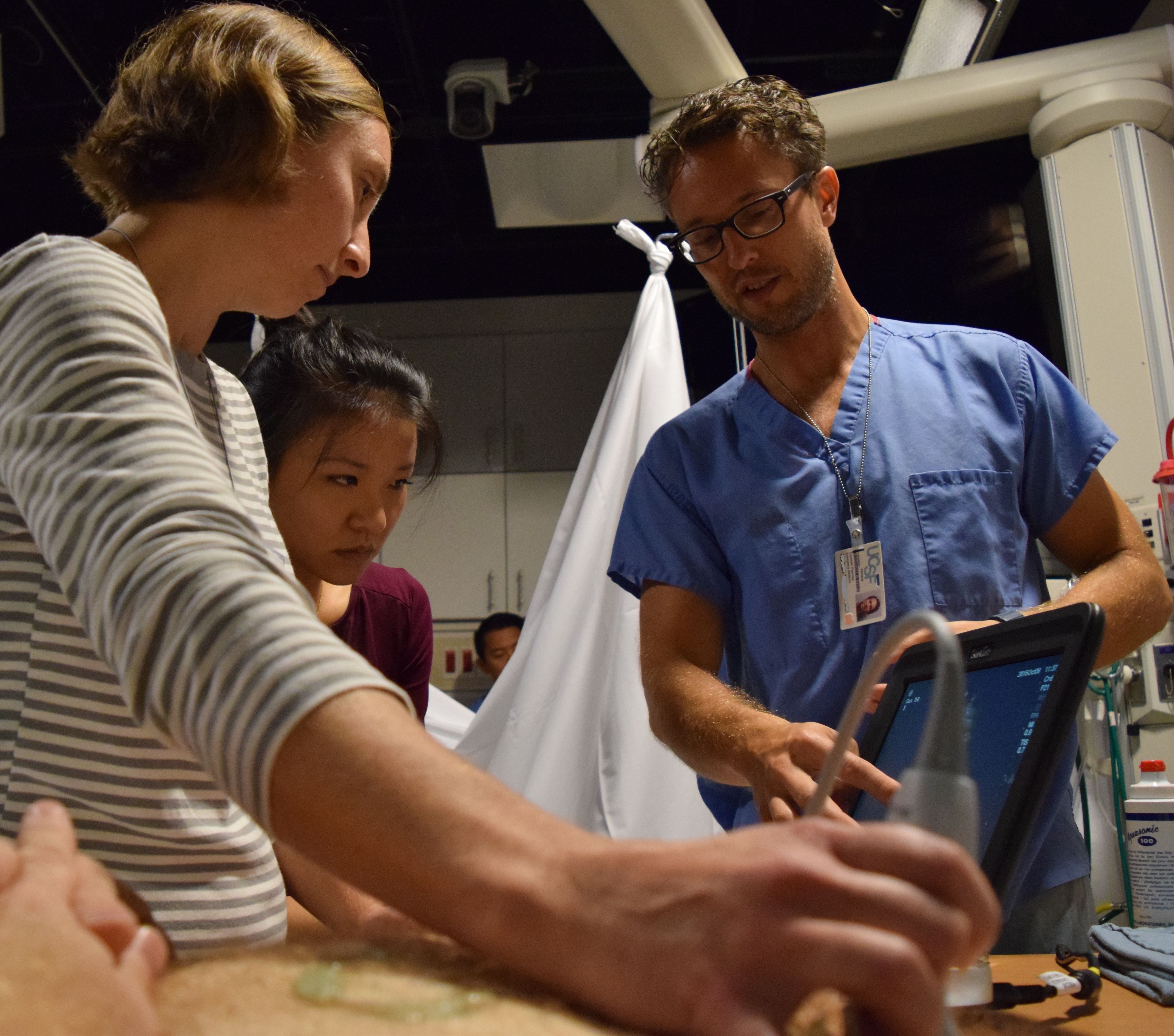 Students and instructor using ultrasound on a standardized patient