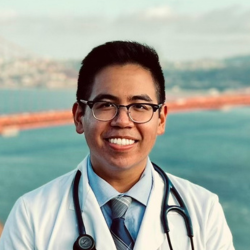 Close up of a man standing in front of a bridge