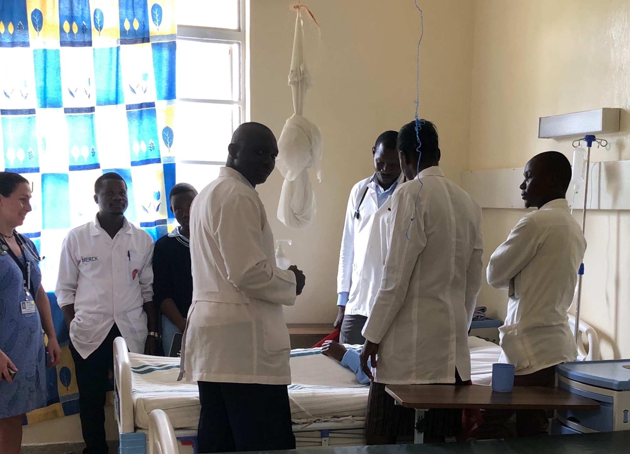 Medical students at a patient's bedside