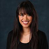 headshot of woman with long dark hair and black blazer
