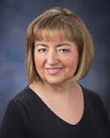 headshot of white woman with short blond hair