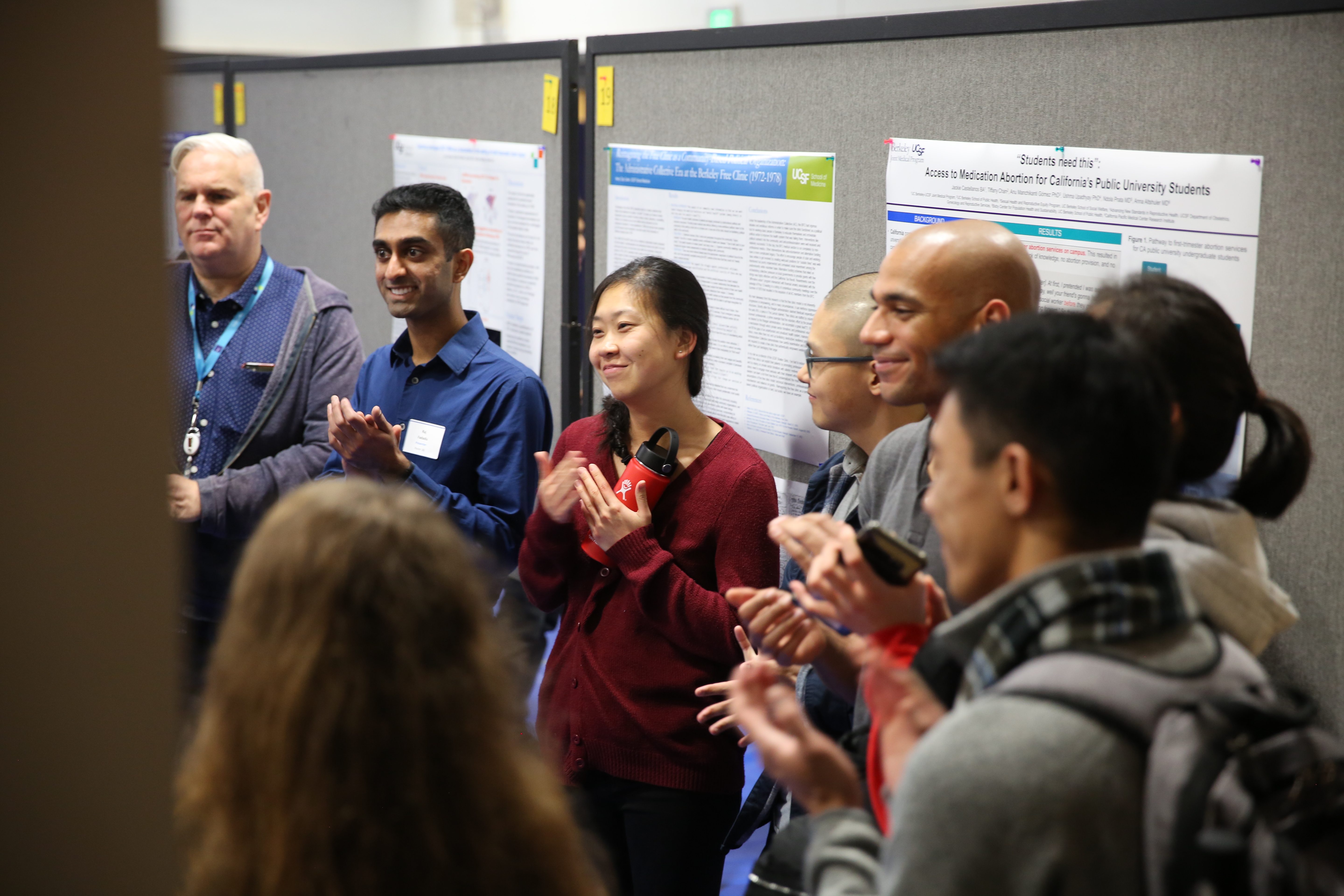 Student presenting research poster at summer explore symposium