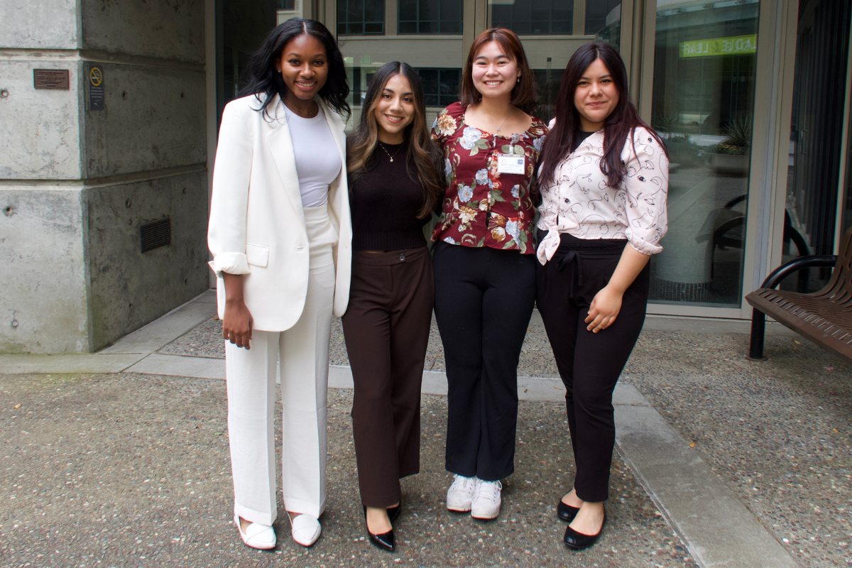 Group of four people pose for a photo