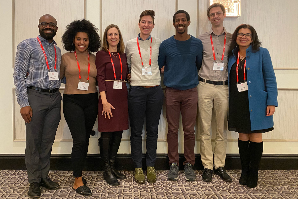 A group of people standing and smiling