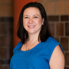 woman in blue dress with medium length brown hair