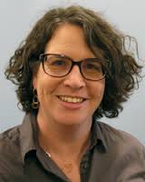 headshot of white woman with medium brown hair wearing eyeglasses