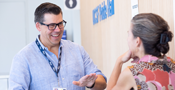 image of two faculty members engaged in conversation
