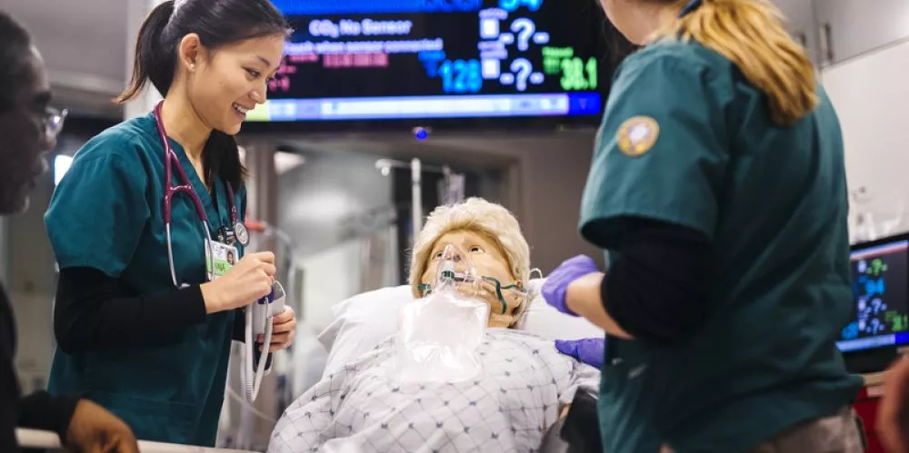 students work with a patient mannequin at the kanbar center