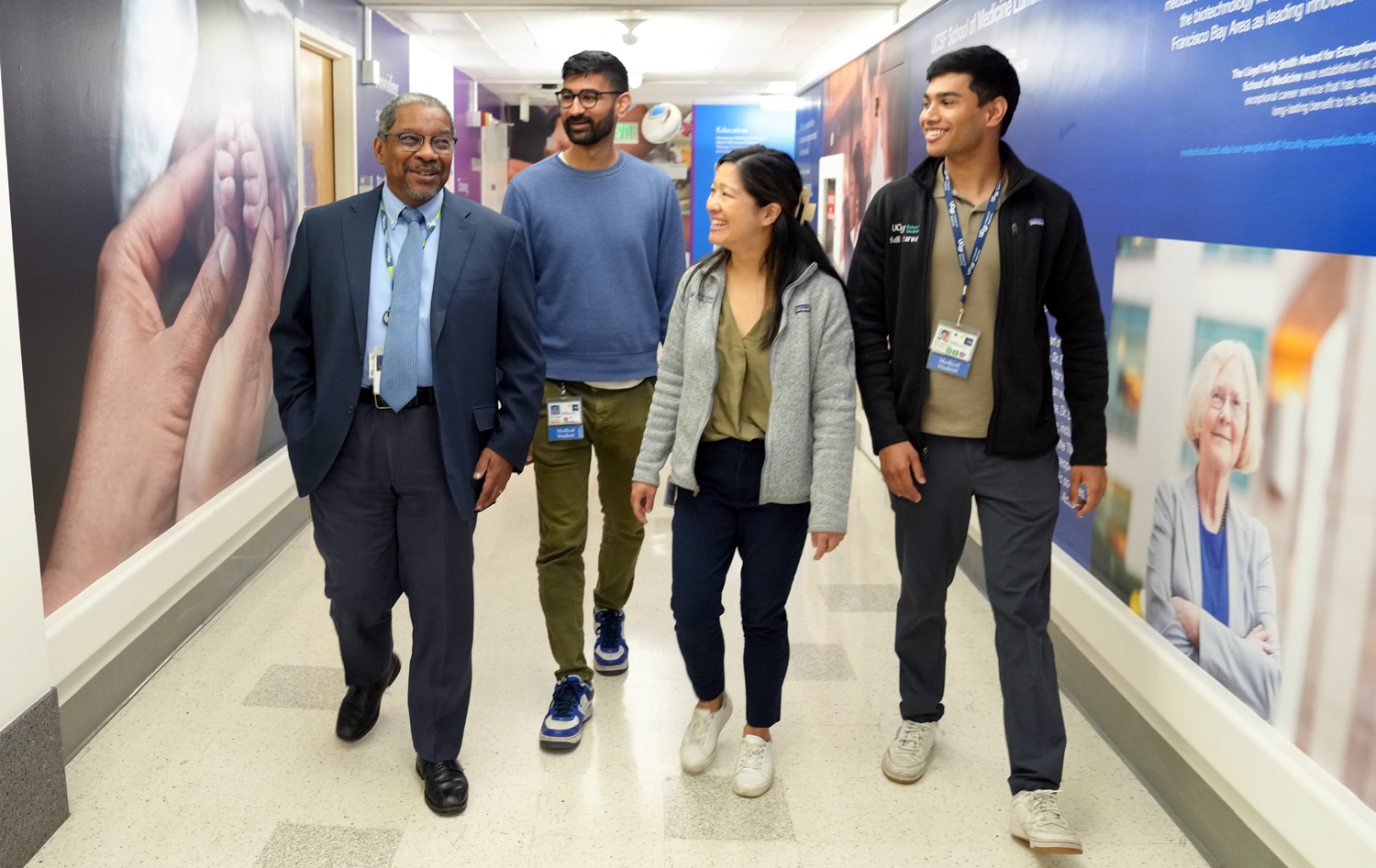 Dean Talmadge King walking with medical students on the side of him