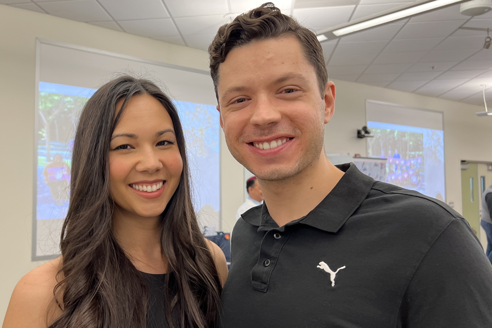 Two people standing next to each other