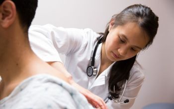SPAN student examining a patient