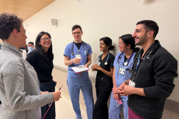 Jessica Abrolat, MS1, Kimberly Luu, MD, Matthew Allen, MS1, Isha Maniyar, MS1, Saffanat Sumra, MS1, and Daniel Rouhani, MS1, in conversation during a clinical skills training at the Kanbar Center for Simulation and Clinical Skills. 