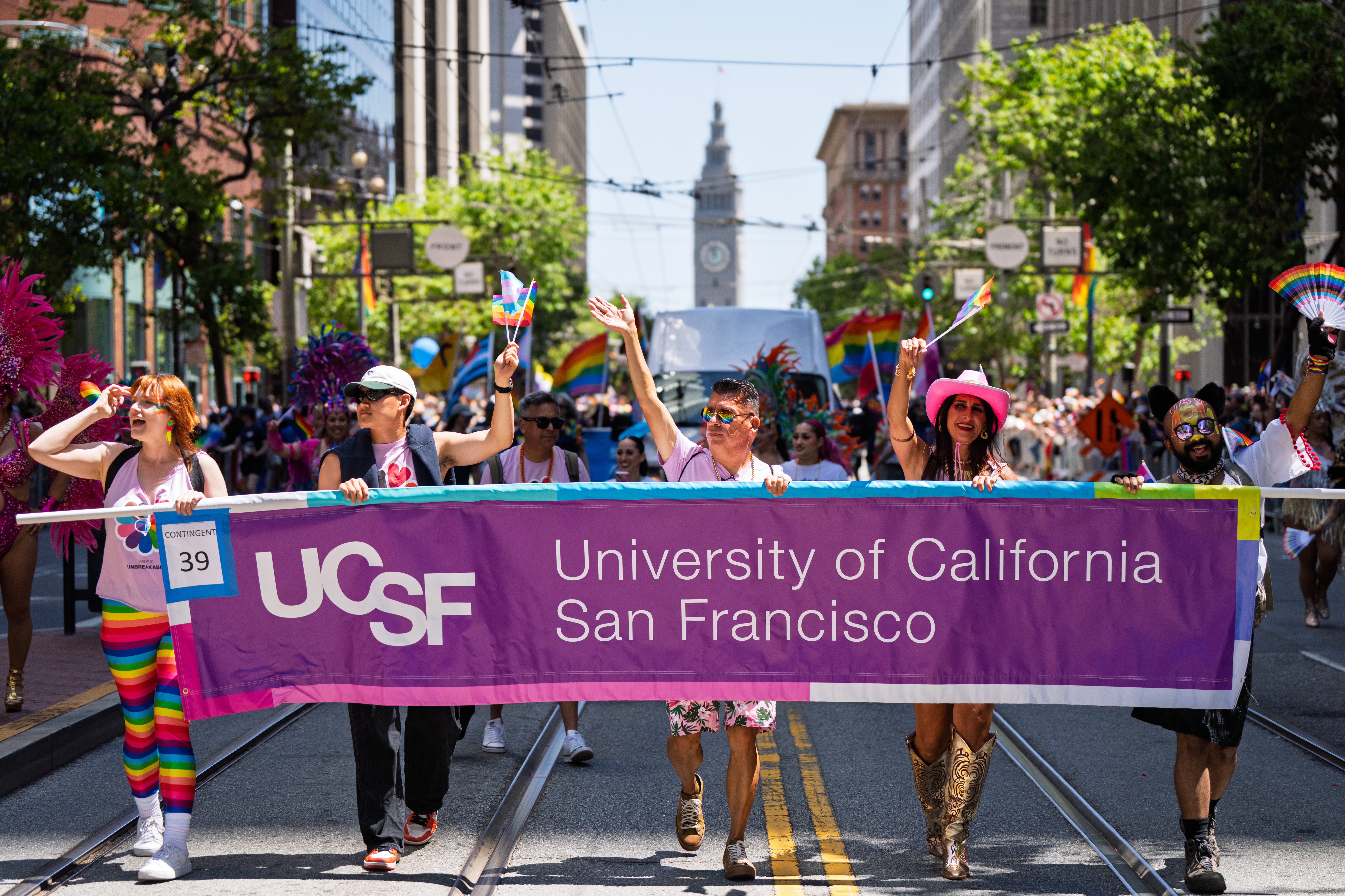 UCSF employees walking behind a UCSF banner in SF Pride Parade