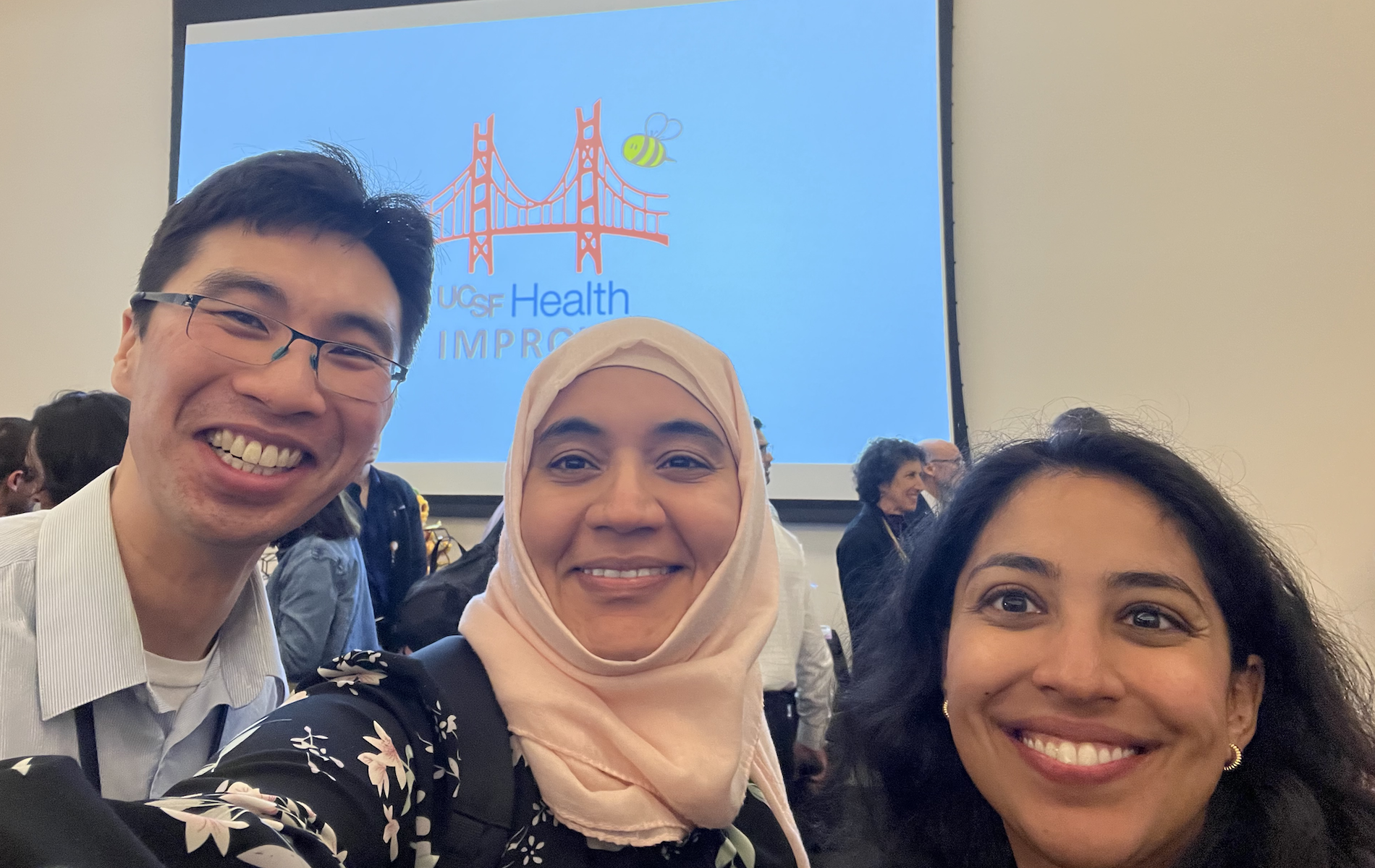 three residents smiling at the Improve symposium