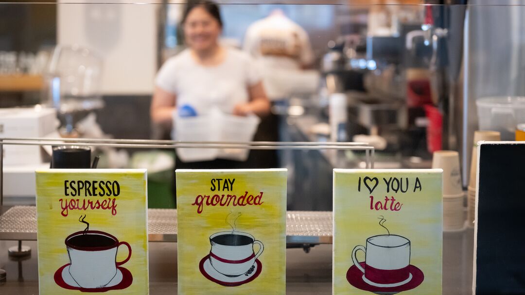 signs with coffee idioms in a window and blurred background