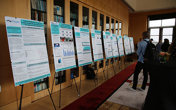 a row of poster boards on easels set up for display