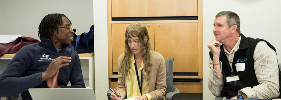 three workshop attendees talking